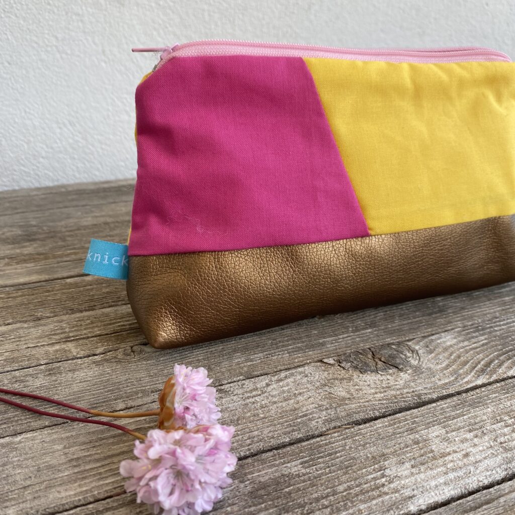 genähte Kosmetiktasche in pink und gelb kombiniert mit kupferfarbenem Kunstleder