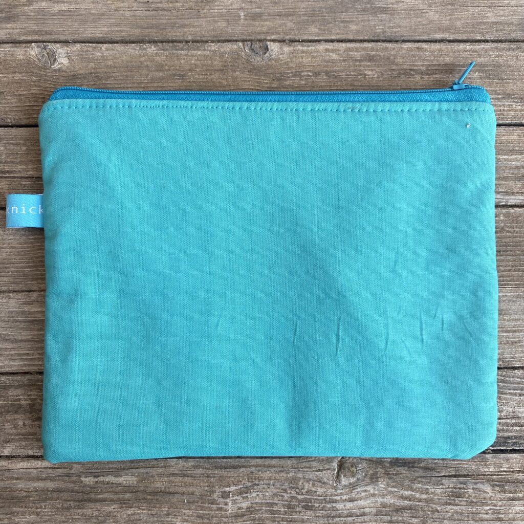 You´re never fully dressed without a smile - Tasche türkis mit orangener Schrift - Rückseite